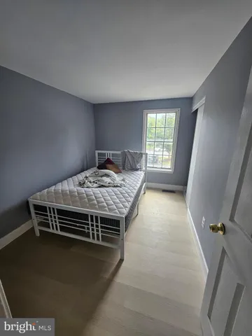 a bed sitting in a bedroom next to a window