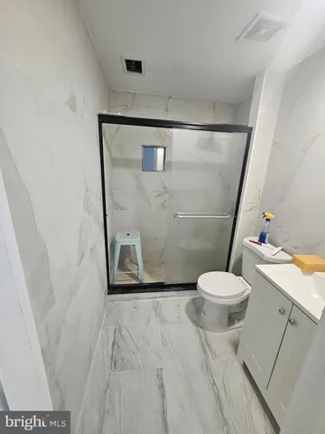 a bathroom with a toilet and a shower