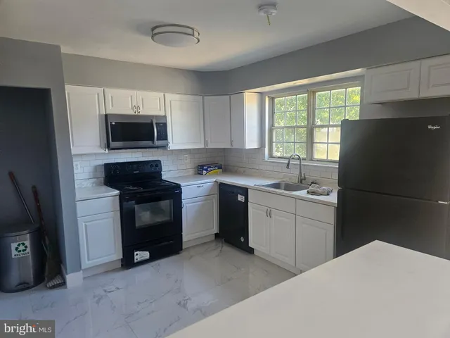 a kitchen with a refrigerator stove and microwave