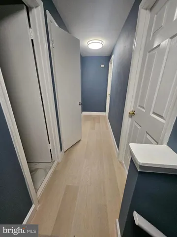 a view of a livingroom with wooden floor and stairs
