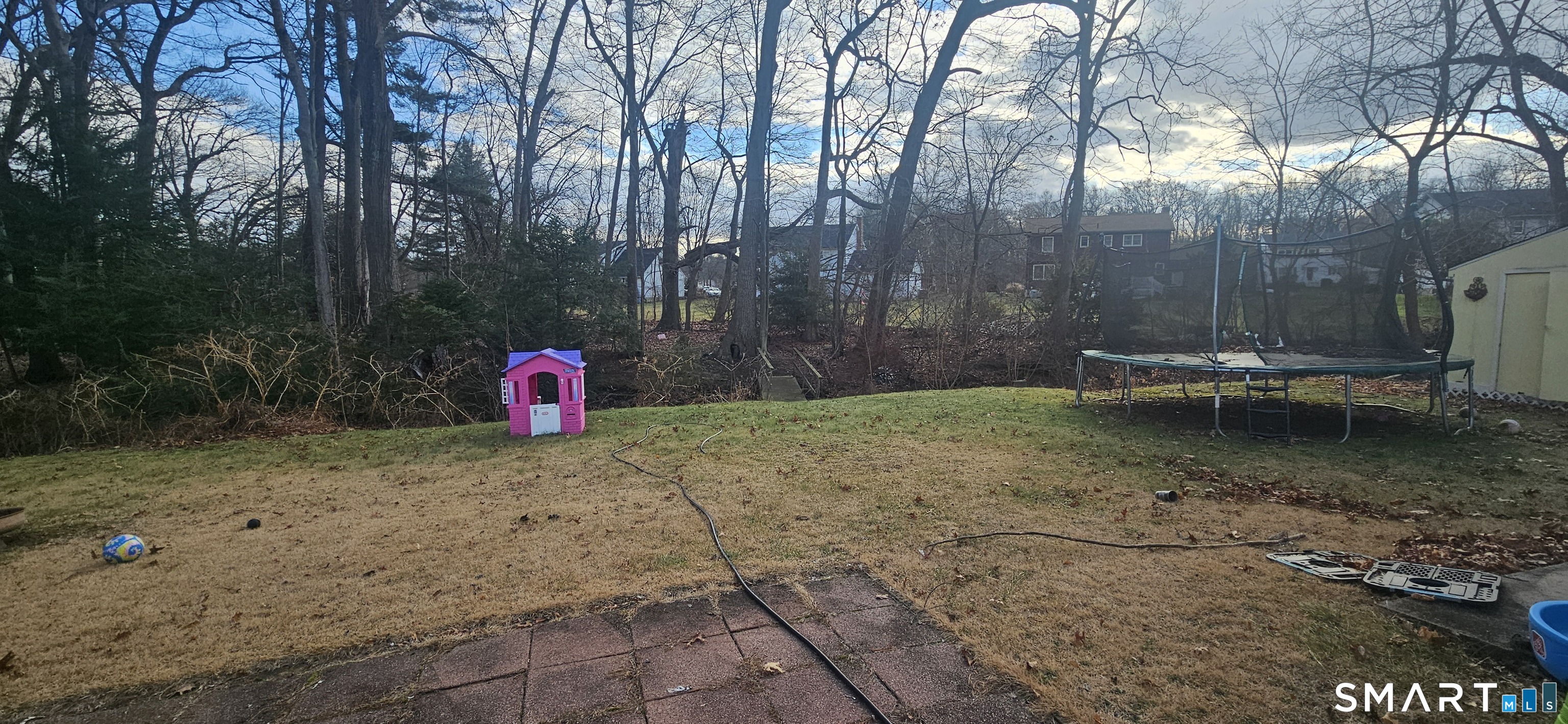60 Nod Road Windsor, CT 06095 - Photo 37 of 38 a backyard of a house with a fountain and a tree