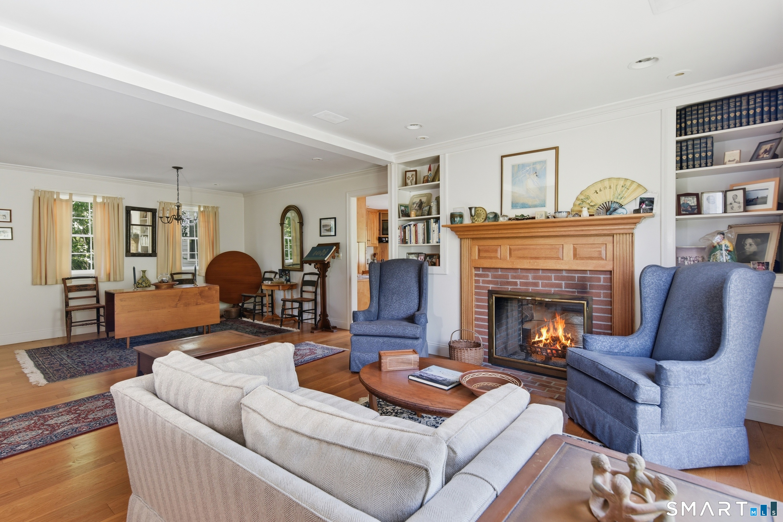 511 Perrin Road Woodstock, CT 06281 - Photo 14 of 40 A back-to-back wood-burning fireplace graces the living room.