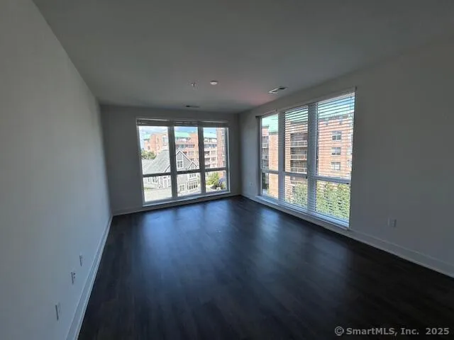 a view of wooden floor and windows in a room