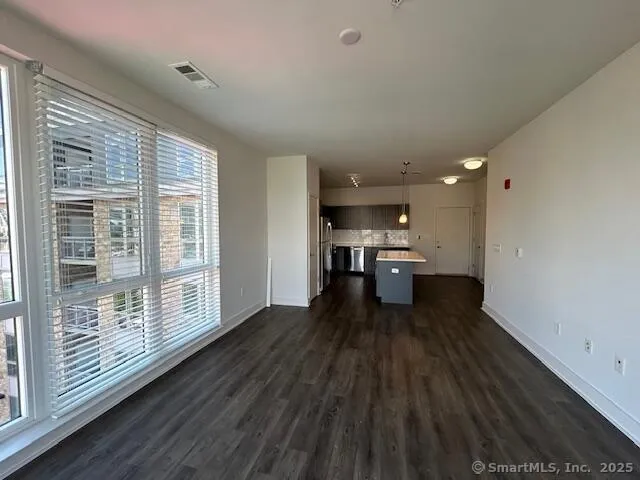 a kitchen with stainless steel appliances granite countertop a sink a stove and a refrigerator