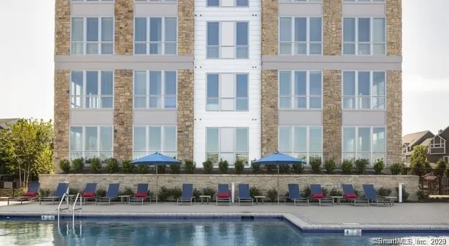 a view of a swimming pool with outdoor seating