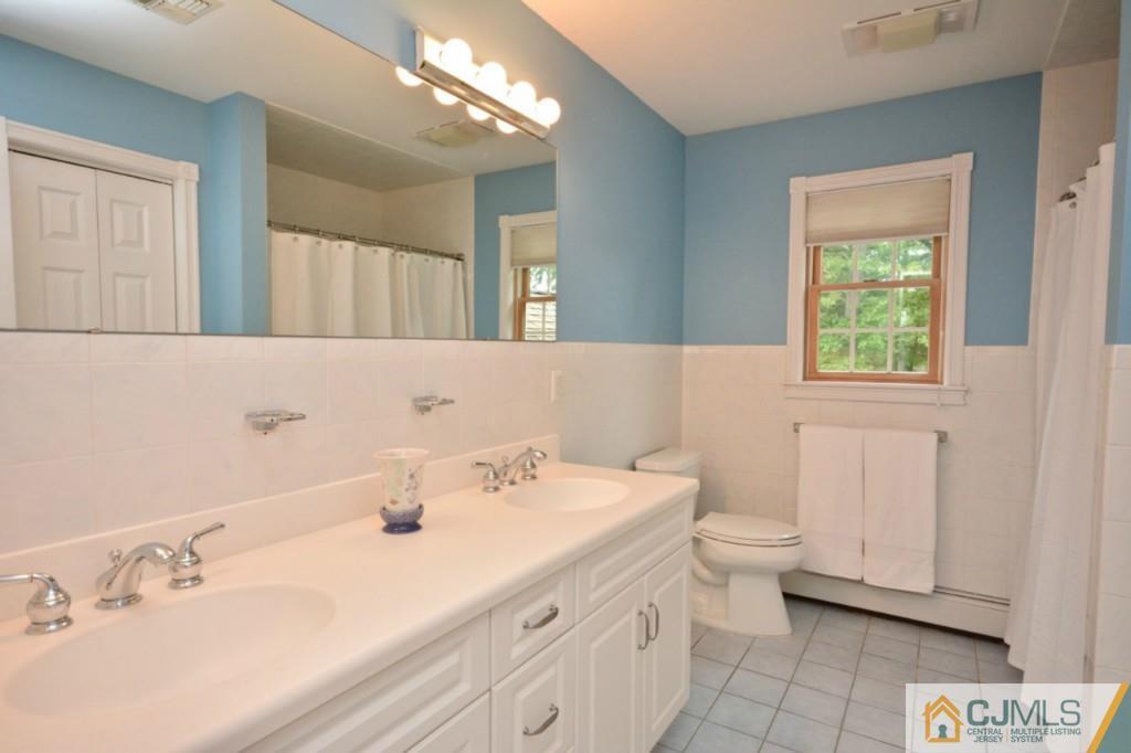 135 Dey Road Cranbury, NJ 08512 - Photo 16 of 25 a bathroom with a sink a toilet and a mirror