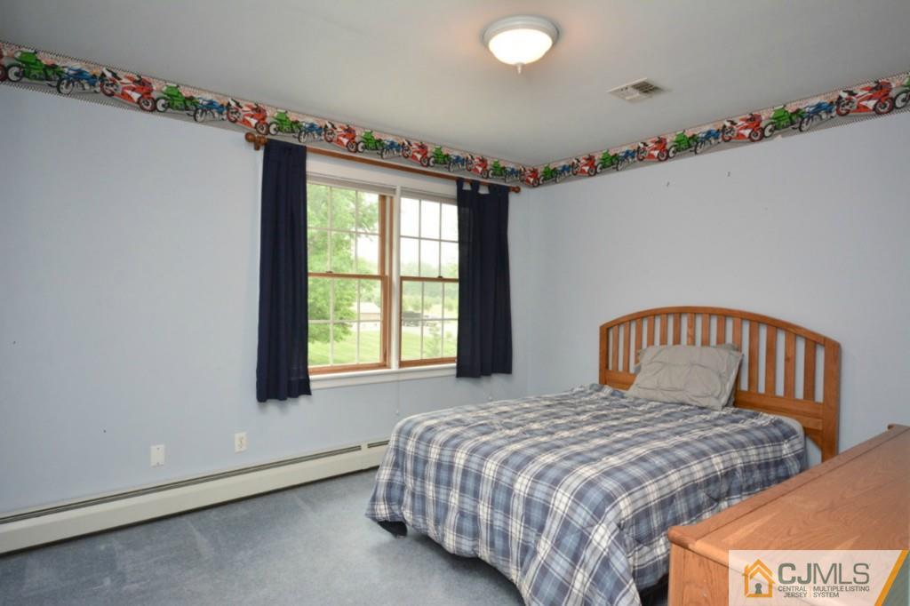135 Dey Road Cranbury, NJ 08512 - Photo 17 of 25 a bedroom with a bed and a window