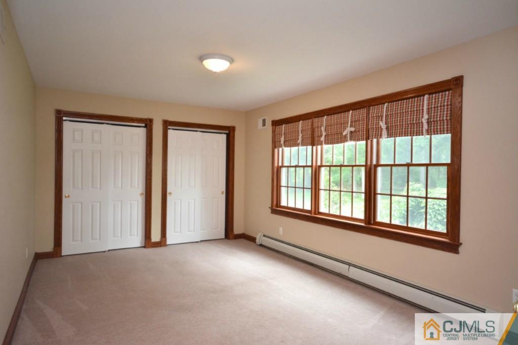135 Dey Road Cranbury, NJ 08512 - Photo 4 of 25 a view of an empty room with a window