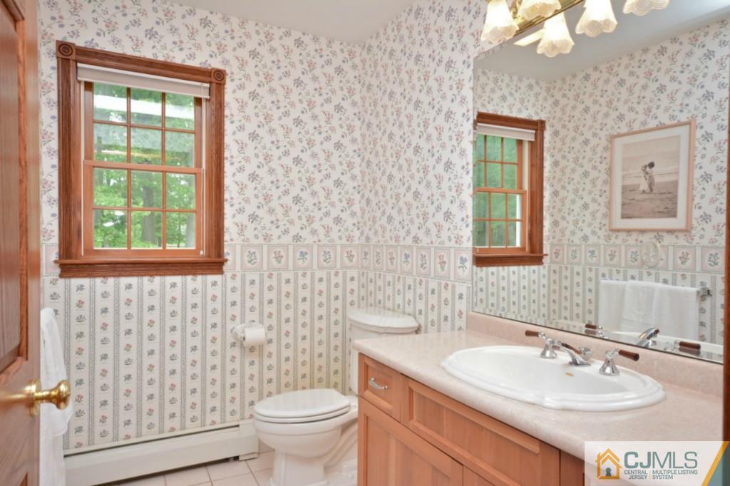 135 Dey Road Cranbury, NJ 08512 - Photo 5 of 25 a bathroom with a sink a toilet and mirror