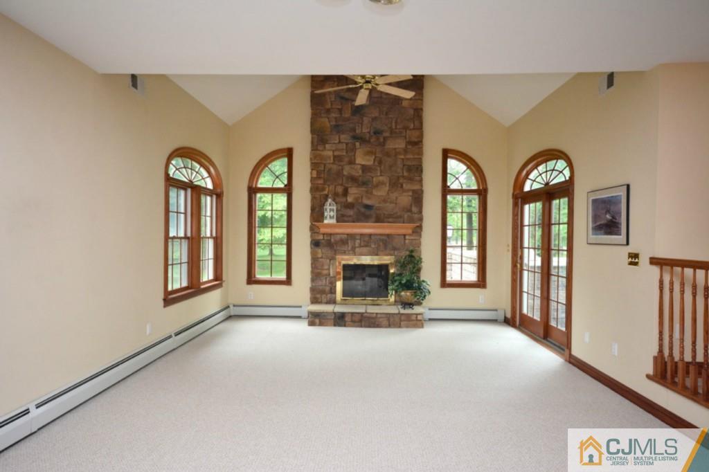 135 Dey Road Cranbury, NJ 08512 - Photo 7 of 25 a view of a room with large windows and a fireplace