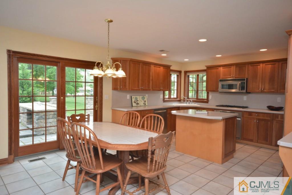 135 Dey Road Cranbury, NJ 08512 - Photo 8 of 25 a kitchen with kitchen island granite countertop wooden cabinets and a granite counter tops