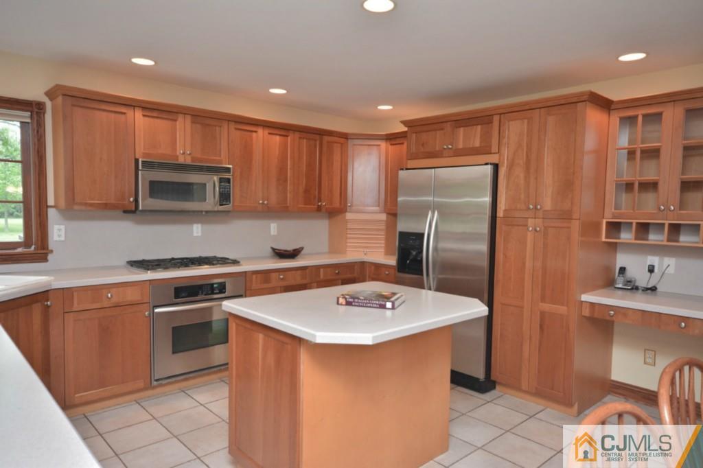 135 Dey Road Cranbury, NJ 08512 - Photo 9 of 25 a kitchen with stainless steel appliances granite countertop a sink stove microwave and refrigerator