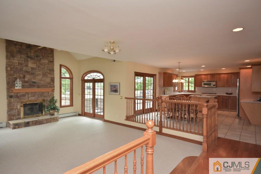 135 Dey Road Cranbury, NJ 08512 - Photo 10 of 25 a view of a livingroom with furniture fireplace window and wooden floor