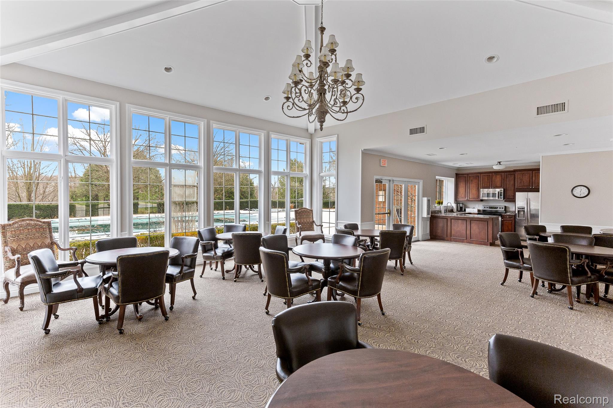 3553 Oakmonte Boulevard Rochester, MI 48306 - Photo 38 of 42 Spacious common area featuring extensive fenestration, recessed lighting, and a decorative chandelier