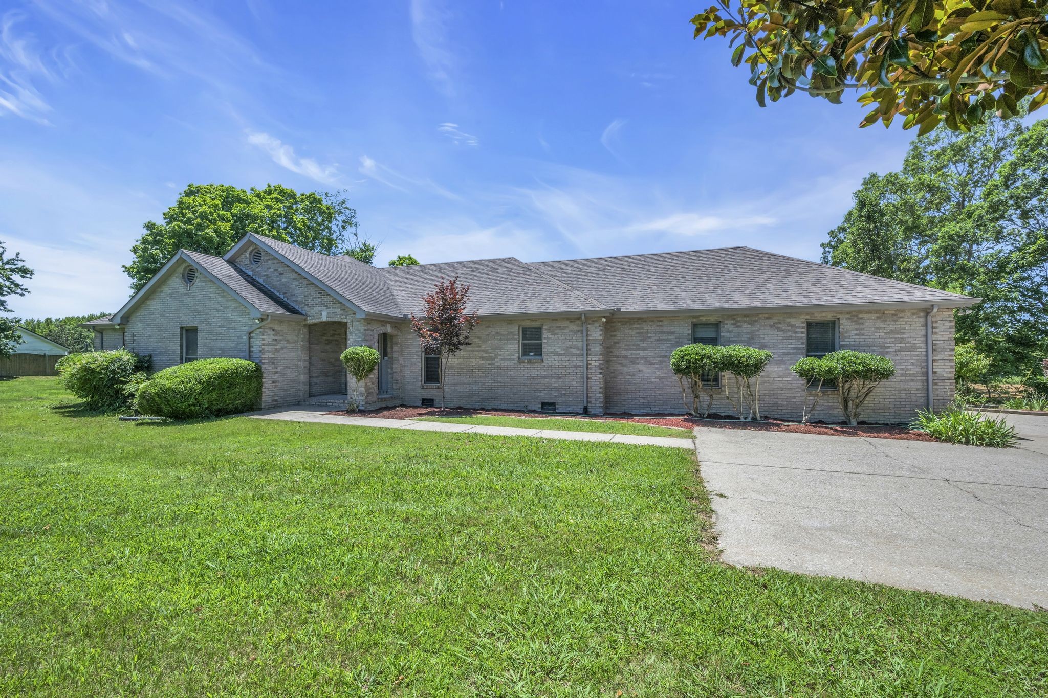 7303 Crow Cut Road Fairview, TN 37062 - Photo 6 of 42 a front view of a house with a yard and garage