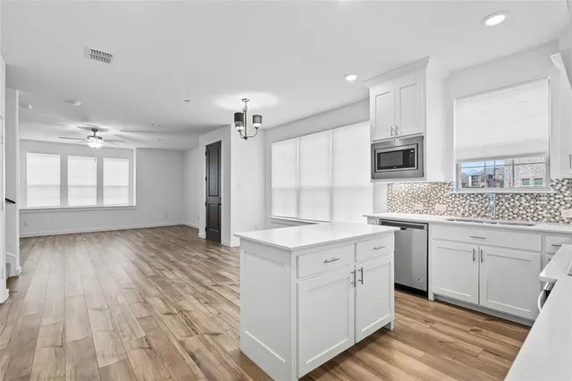 a kitchen with granite countertop a stove and a refrigerator