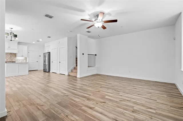 a view of an empty room with a ceiling fan