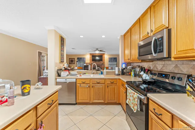 a kitchen with a sink a stove and cabinets