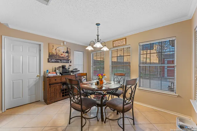a dining room with furniture a chandelier and window