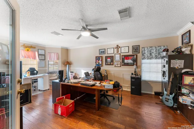 a work room with furniture and wooden floor
