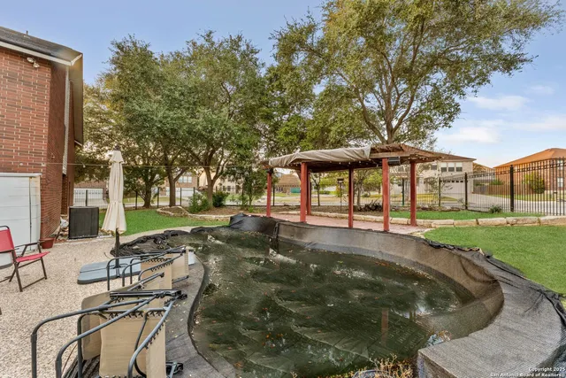 a swimming pool with outdoor seating and yard