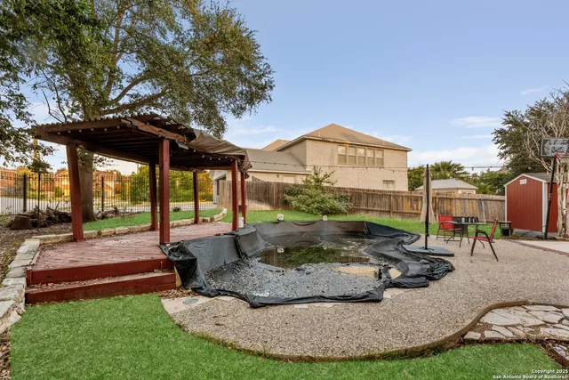 a view of a house with backyard and sitting area