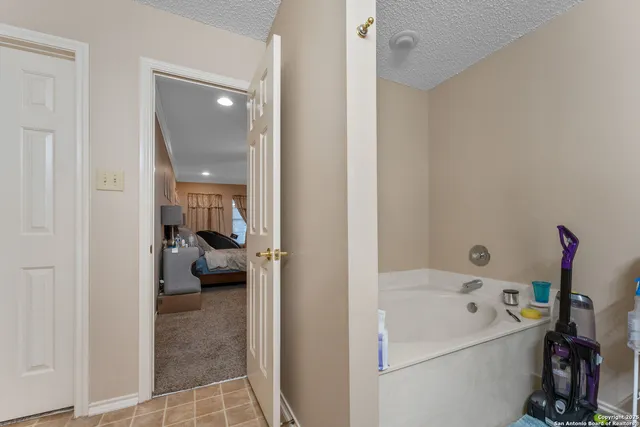 a en suite bathroom with a sink a large mirror and a bath tub