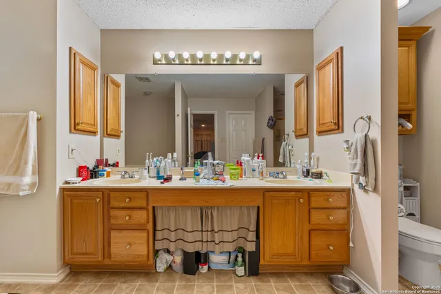 a bathroom with a double vanity sink mirror and