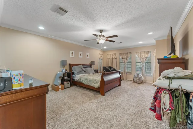 a bedroom with furniture and a chandelier