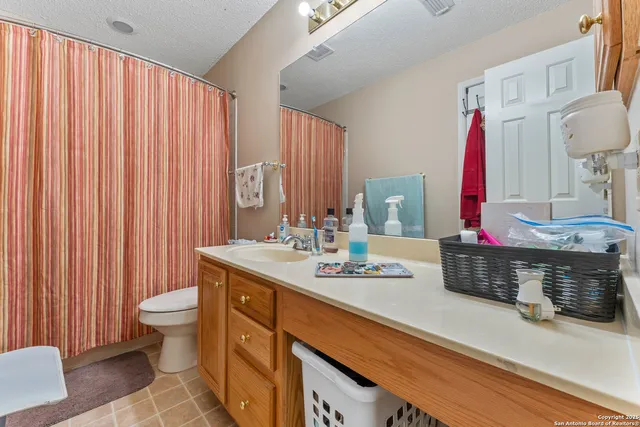 a bathroom with a sink vanity mirror and toilet