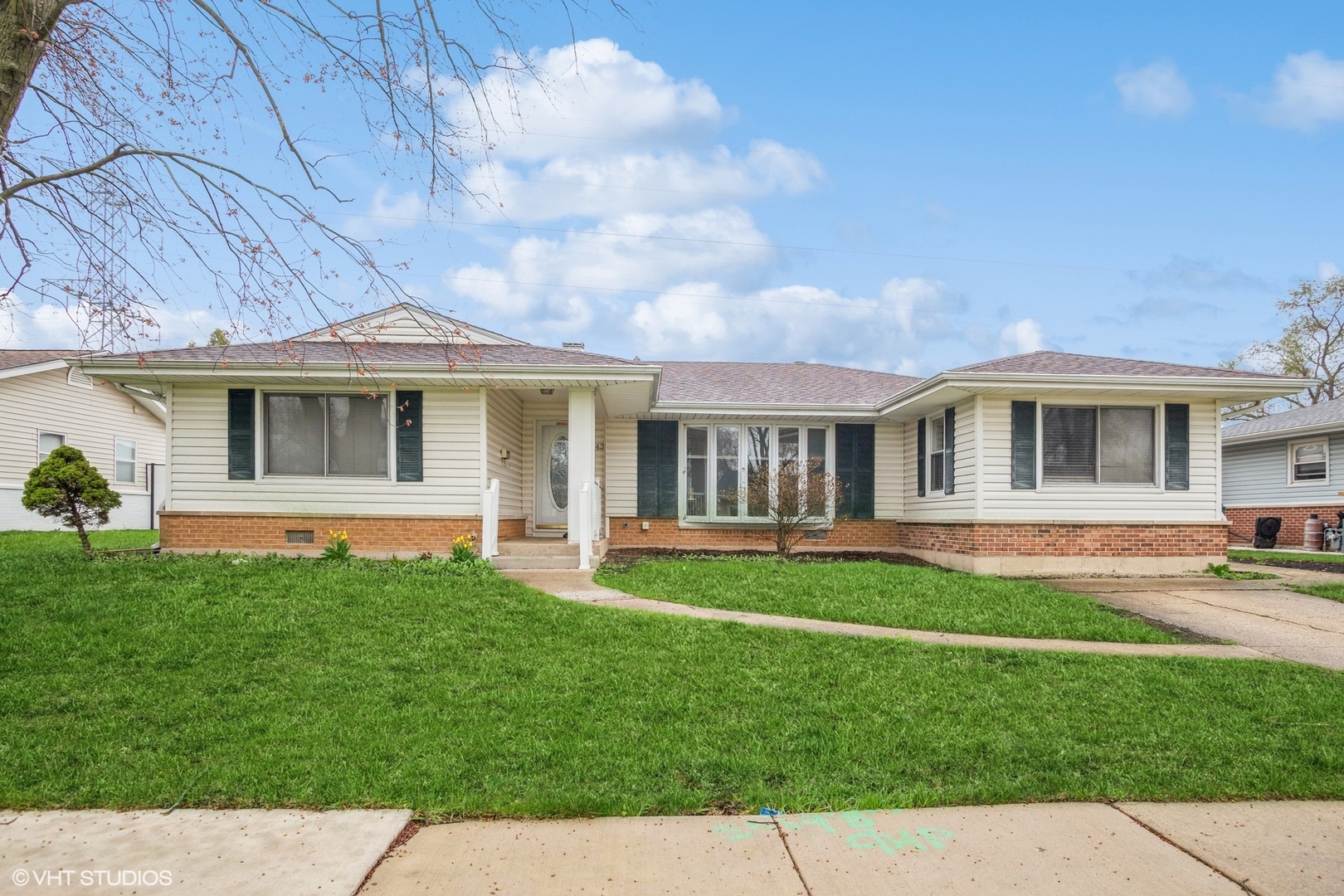943 Maple Lane Elk Grove Village, IL 60007 - Photo 1 of 17 a front view of a house with a yard