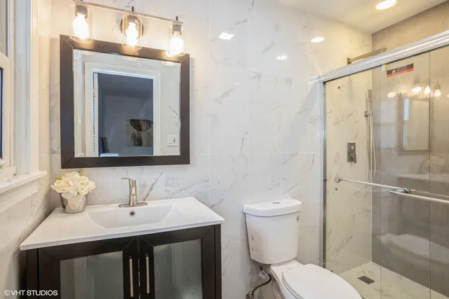 a bathroom with a sink toilet and shower