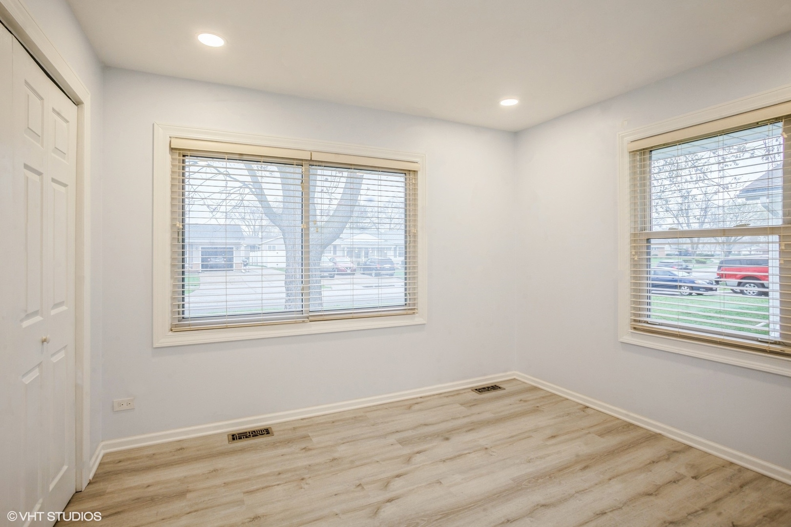 943 Maple Lane Elk Grove Village, IL 60007 - Photo 13 of 17 an empty room with wooden floor and windows