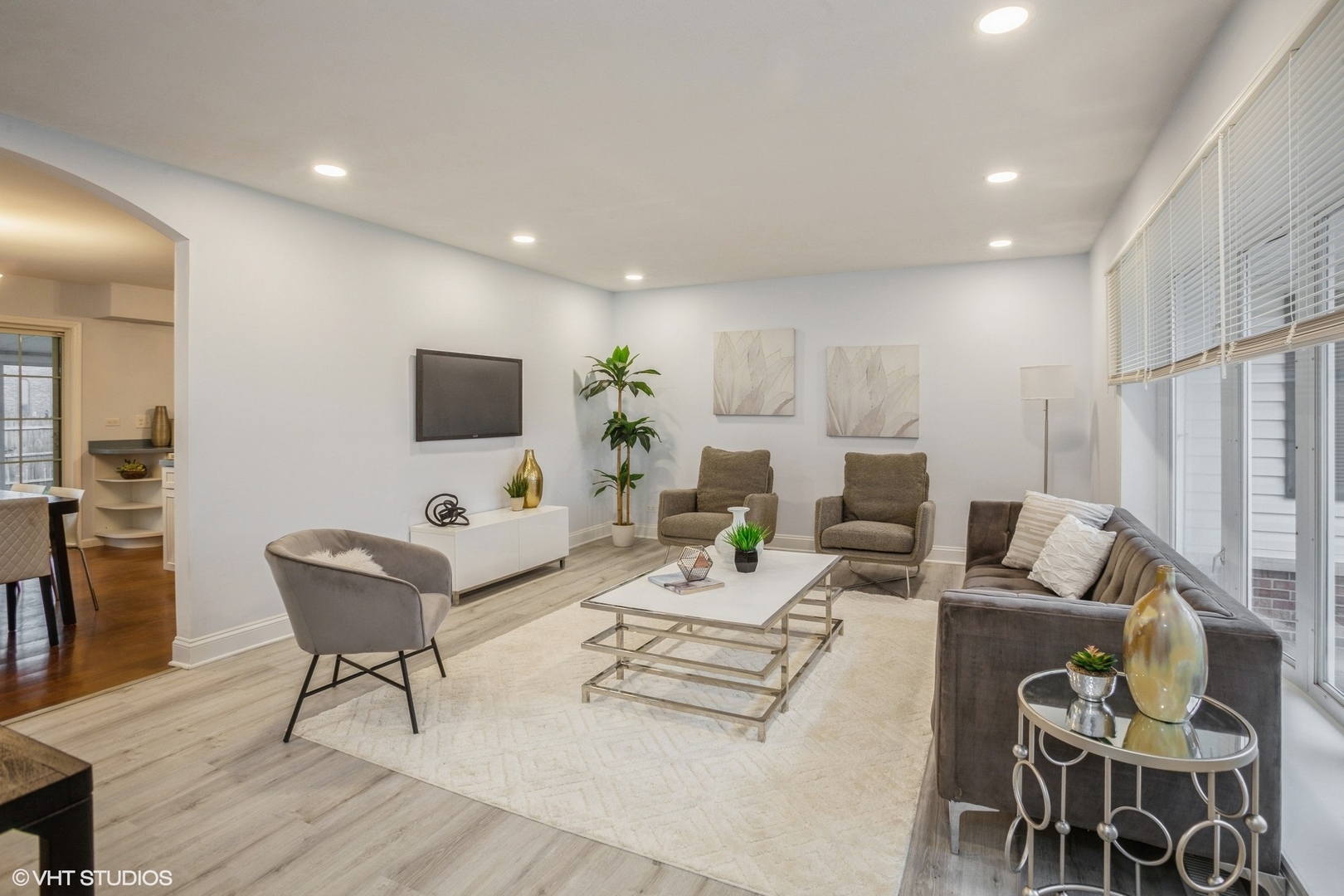 943 Maple Lane Elk Grove Village, IL 60007 - Photo 2 of 17 a living room with furniture a flat screen tv and kitchen view