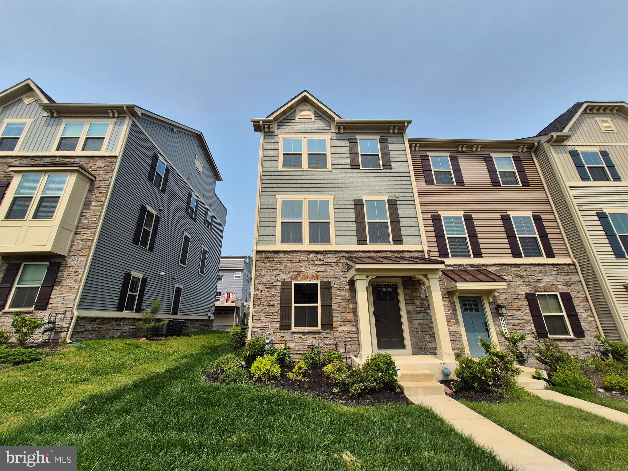 a front view of a residential apartment building with a yard