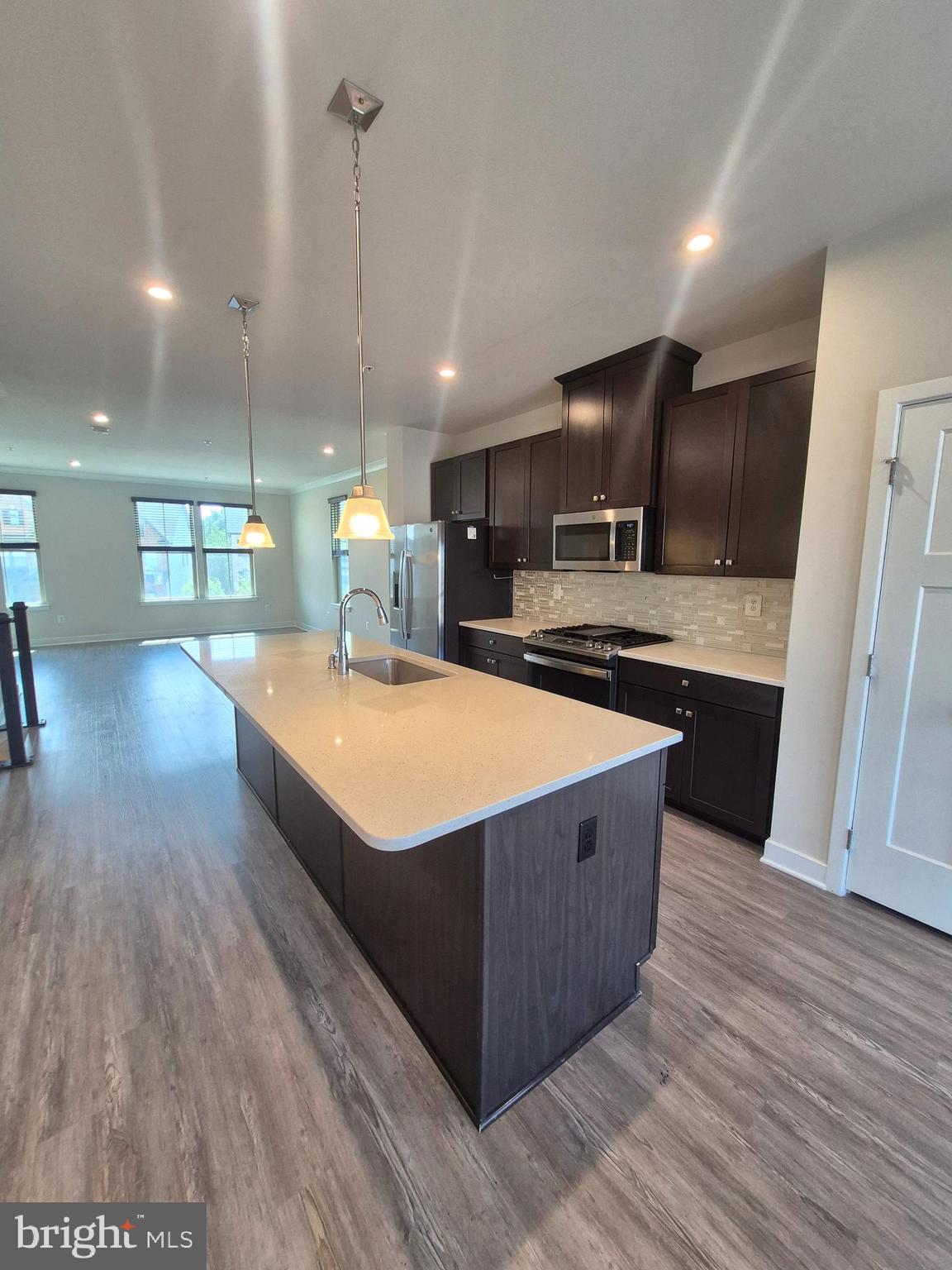 6054 Fallfish Court New Market, MD 21774 - Photo 12 of 28 a kitchen with stainless steel appliances granite countertop a sink a counter space and cabinets