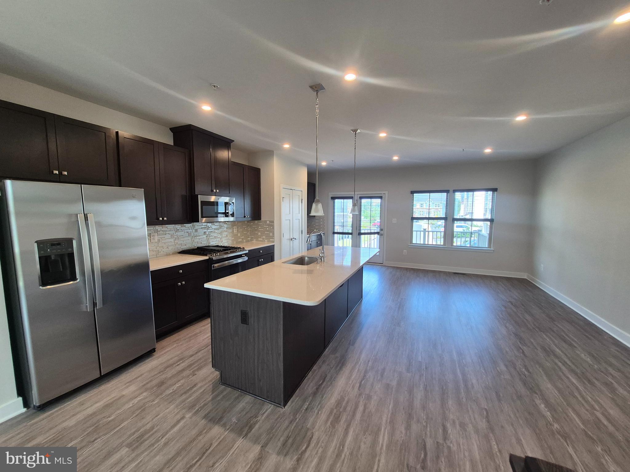 6054 Fallfish Court New Market, MD 21774 - Photo 15 of 28 a kitchen with stainless steel appliances granite countertop a refrigerator a sink dishwasher a stove and a wooden floors