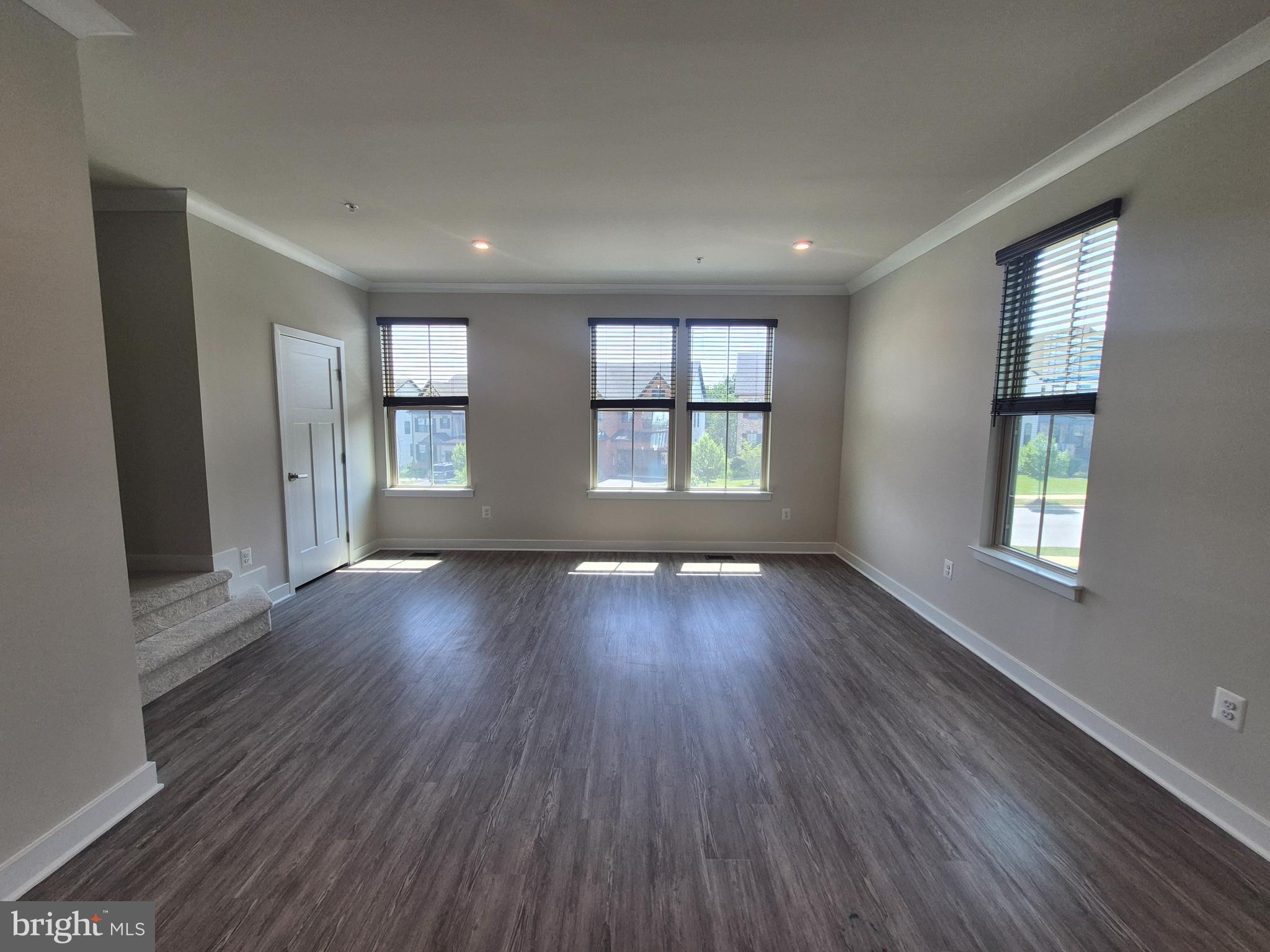 6054 Fallfish Court New Market, MD 21774 - Photo 18 of 28 an empty room with wooden floor and windows