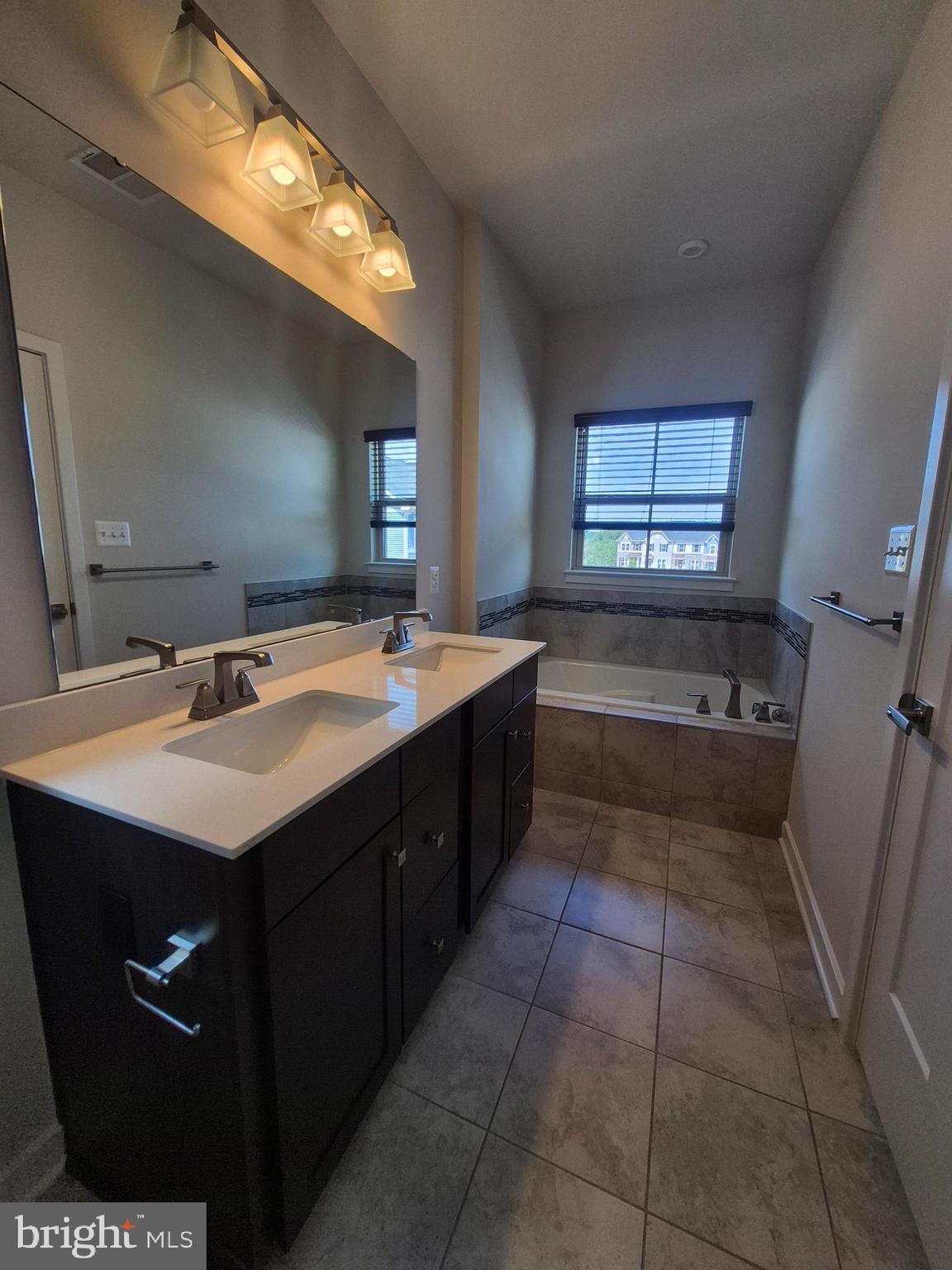 6054 Fallfish Court New Market, MD 21774 - Photo 22 of 28 a bathroom with a sink a vanity and a mirror
