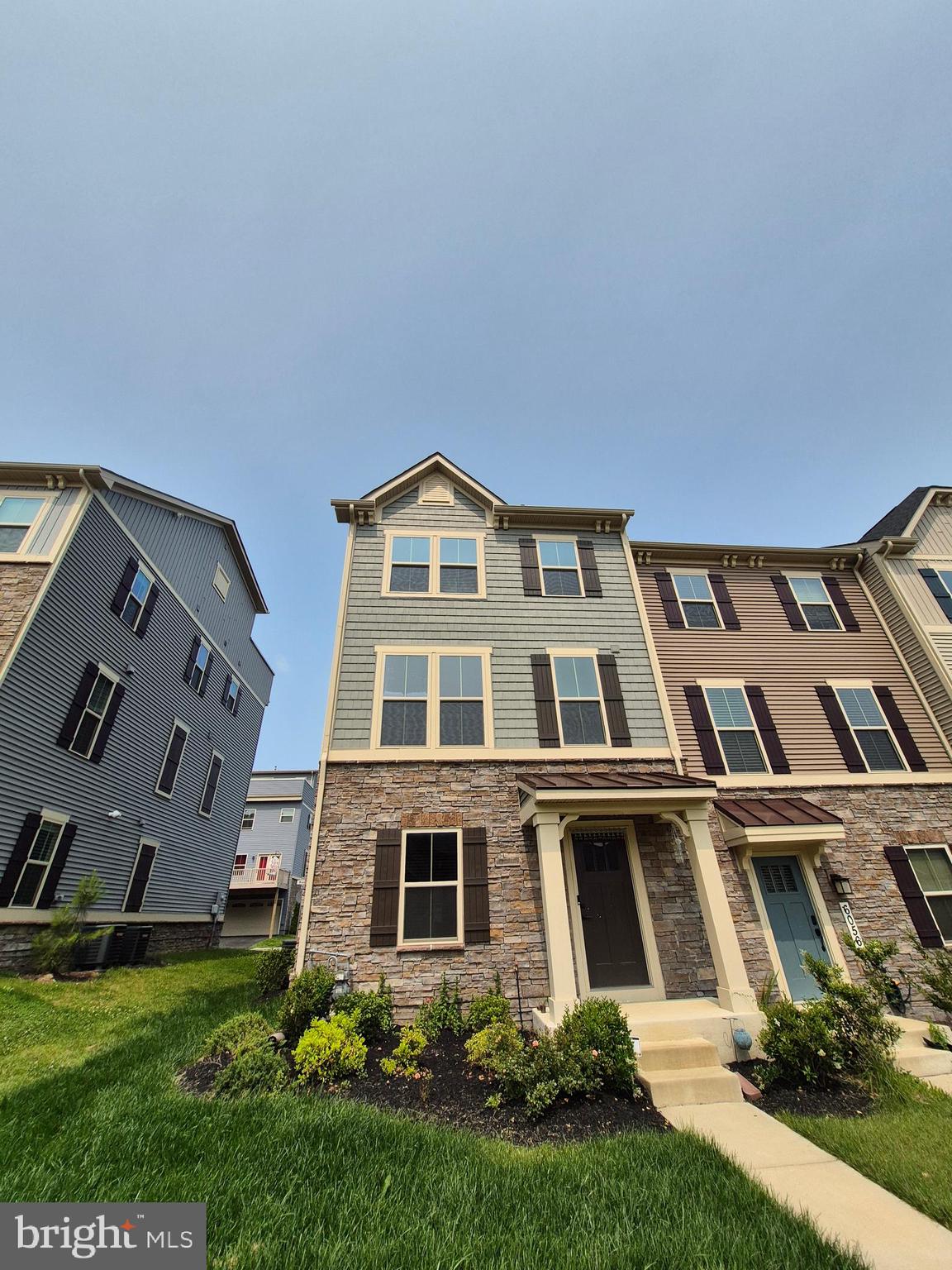 6054 Fallfish Court New Market, MD 21774 - Photo 6 of 28 a front view of a residential apartment building with a yard