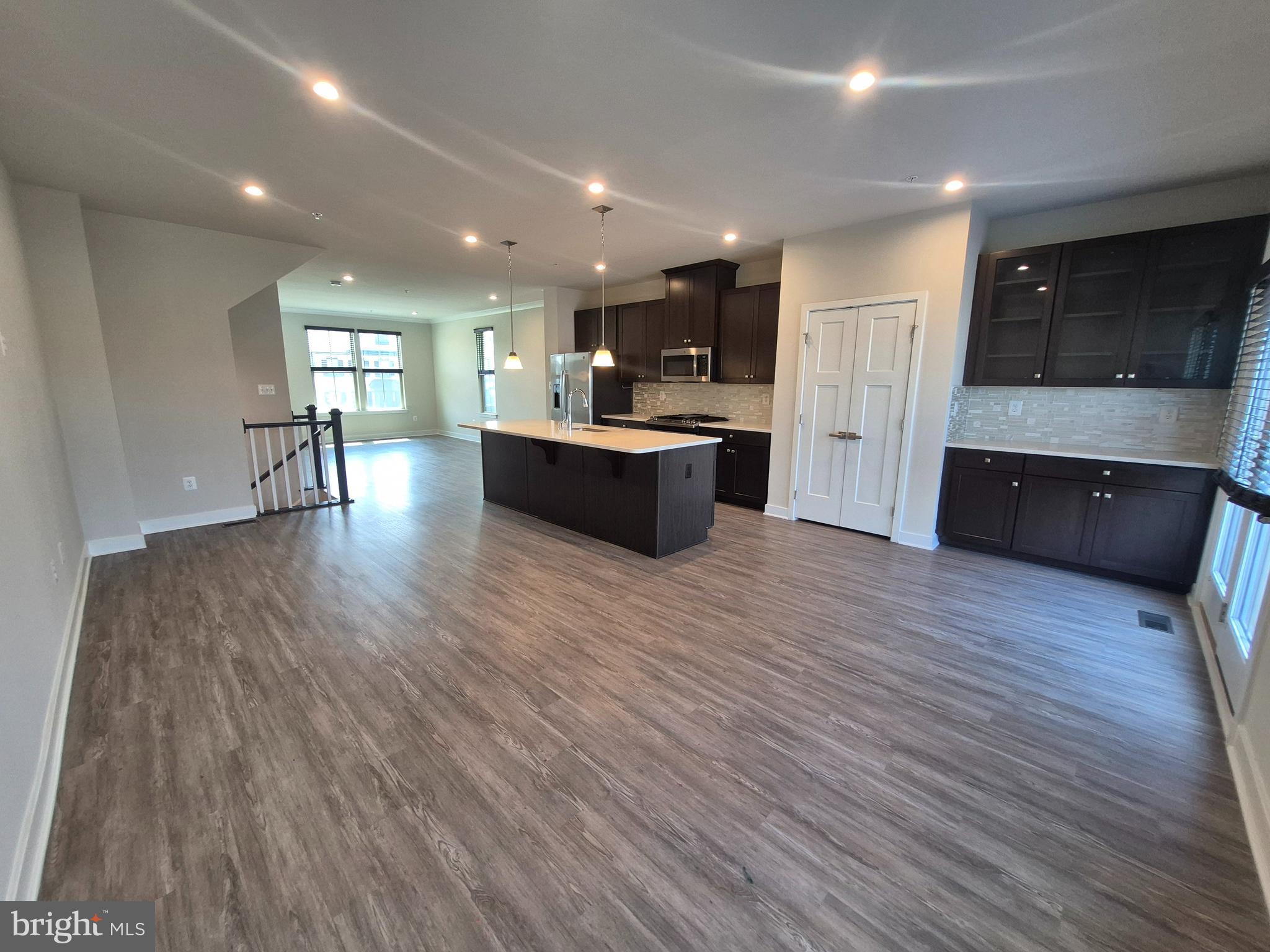 6054 Fallfish Court New Market, MD 21774 - Photo 10 of 28 a view of kitchen with cabinets wooden floor and window