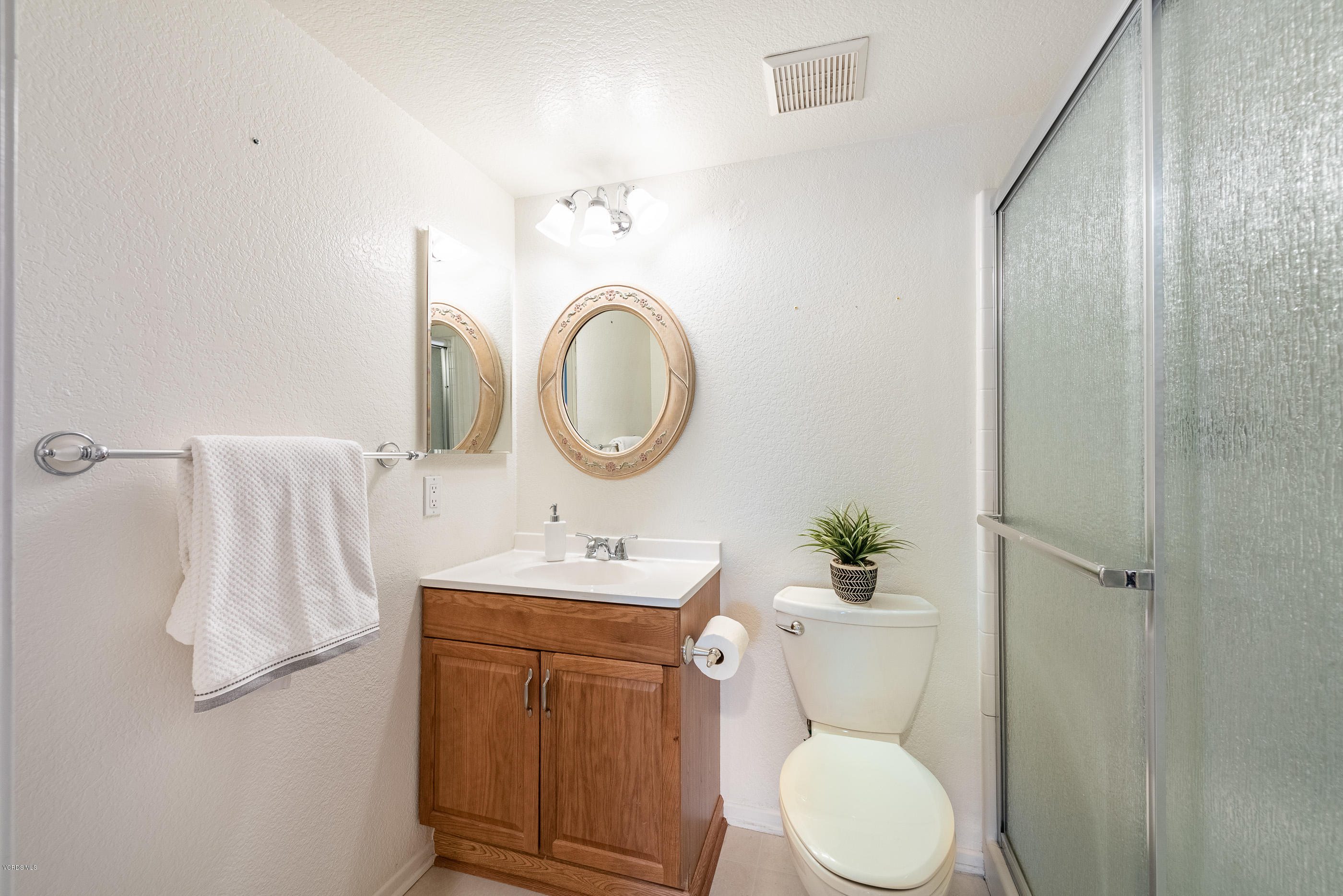 1007 Waltham Road, Unit C Simi Valley, CA 93065 - Photo 16 of 25 a bathroom with a toilet sink vanity granite and a mirror