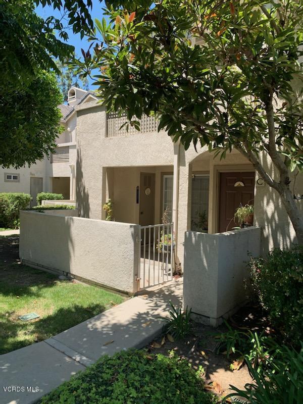 1007 Waltham Road, Unit C Simi Valley, CA 93065 - Photo 25 of 25 a view of a white house with a small yard and large tree