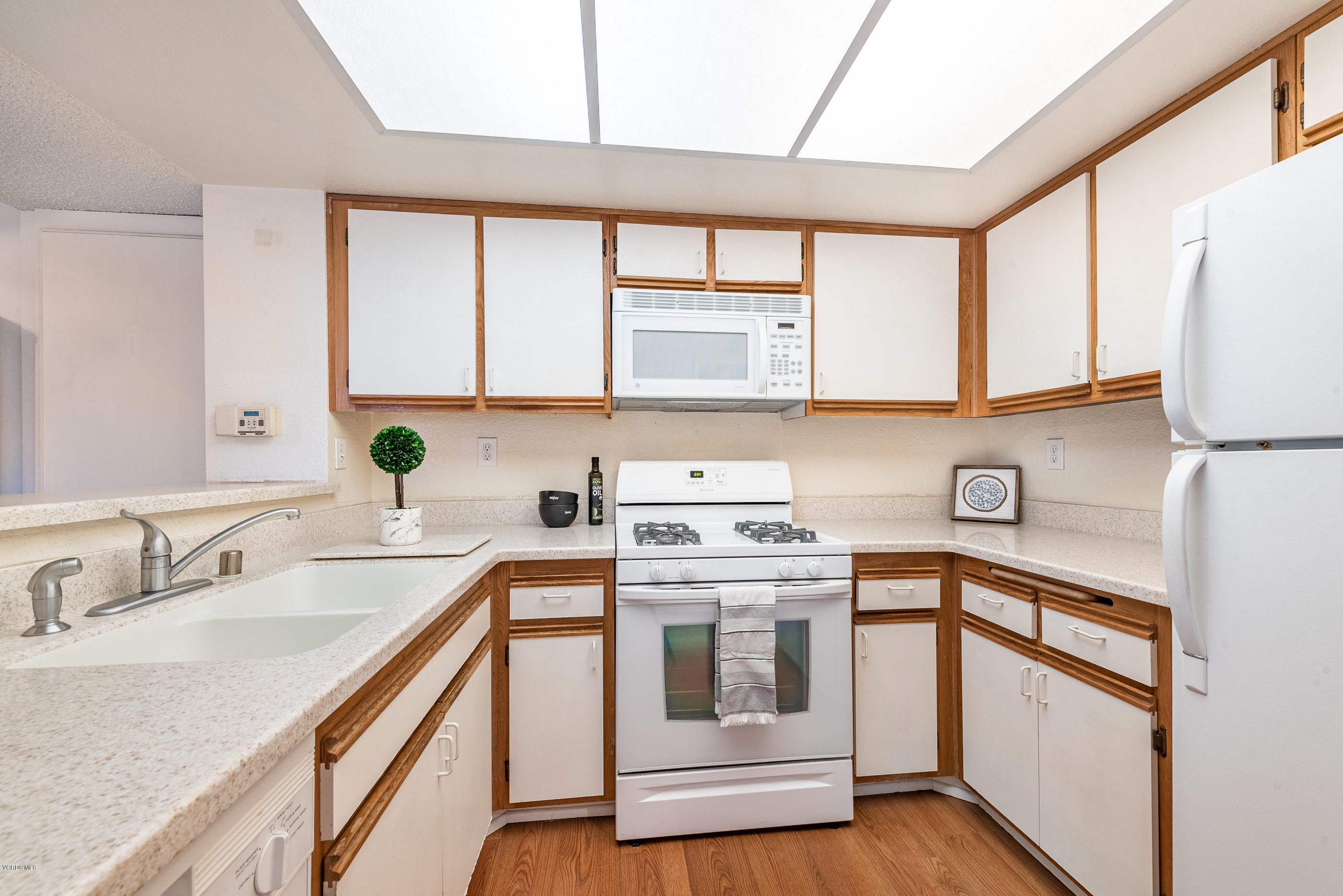 1007 Waltham Road, Unit C Simi Valley, CA 93065 - Photo 7 of 25 a kitchen with stainless steel appliances granite countertop a sink a stove and a refrigerator