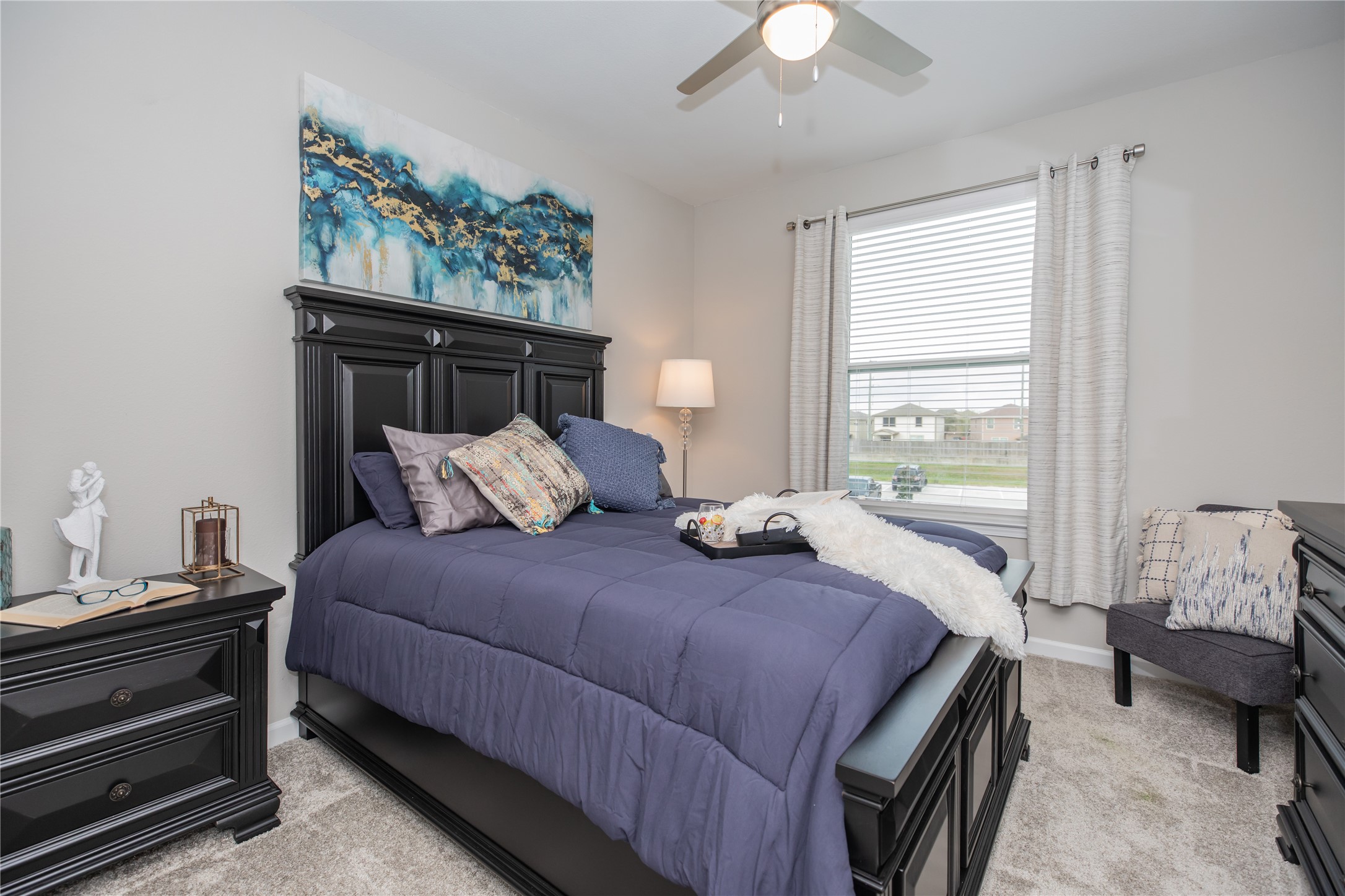 14809 Ralston Road, Unit A18302 Humble, TX 77396 - Photo 10 of 16 a bedroom with a bed and a chandelier