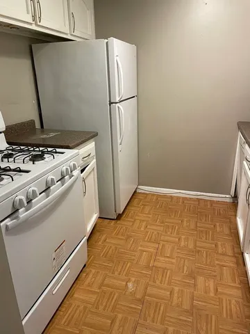 a kitchen with a stove and a refrigerator