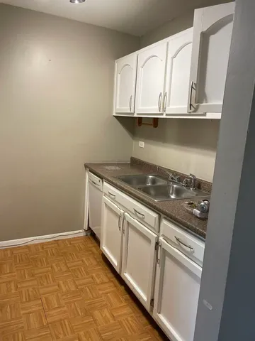 a stove top oven sitting inside of a kitchen