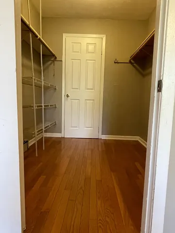 an empty room with wooden floor and a window
