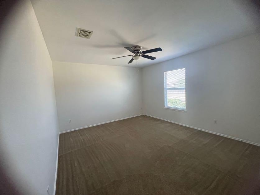 12645 Pricklybranch Drive Fort Worth, TX 76244 - Photo 16 of 21 an empty room with windows and fan