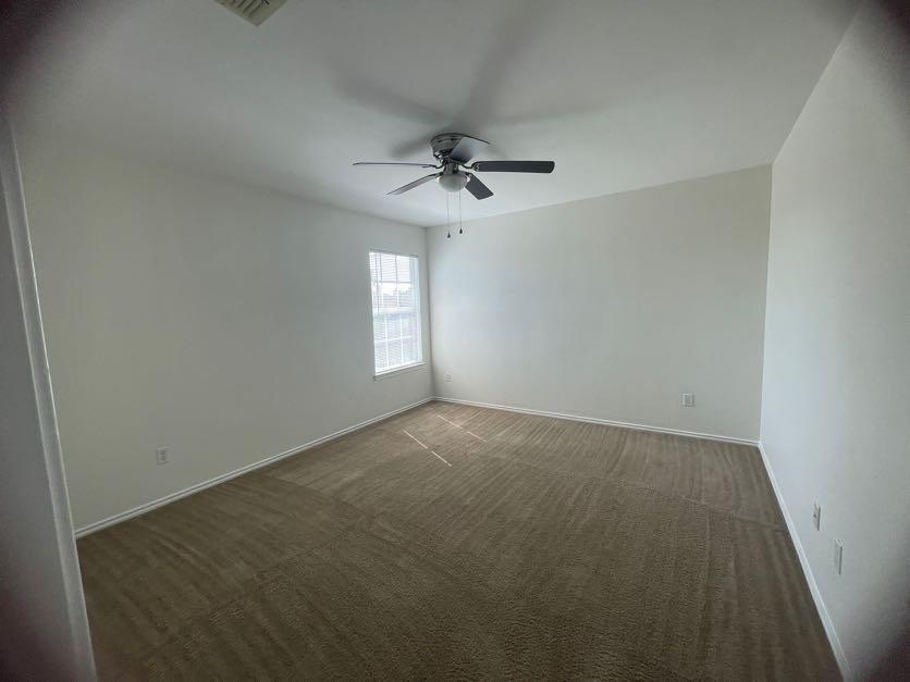 12645 Pricklybranch Drive Fort Worth, TX 76244 - Photo 17 of 21 an empty room with windows and fan